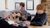 A songwriting workshop at Arts Centre Washington Three young people sitting at a table with a tablet in front of them. One is playing an acoustic guitar.
