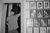 Harry Griffin, The Mayor, Evesham, 2024. Courtesy of the artist. Comedian Ivor Graham stands in a door way. The door way has a curtain which is pulled back. Next to the doorway are a number of framed pictures of mayors.