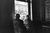 Harry Griffin, Tropical view, Queen's Heath Pride, June 2023. Courtesy of the artist. Comedian Joe Lycett and a female friend stare at a parade from the window of a Birmingham Pub.