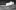 Ian-Mac-Talk-aspect-ratio-16-9 A black and white image of a large metal structure on it's side. It is surrounded by pieces of metal and train tracks.