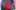 Dean-Raymond-Gooch-Image-3-scaled-aspect-ratio-16-9 A man photographed from behind. He is naked from the waist up. He is wearing blue jeans. He has a red patterned cotton neckerchief hanging from his right pocket.