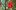 A red mottled glass Christmas bauble hangs on a tree, attached with a red ribbon. The tree has small white globe shaped lights on every branch.