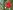 Make Your Own Christmas Bauble 25 A red mottled glass Christmas bauble hangs on a tree, attached with a red ribbon. The tree has small white globe shaped lights on every branch.