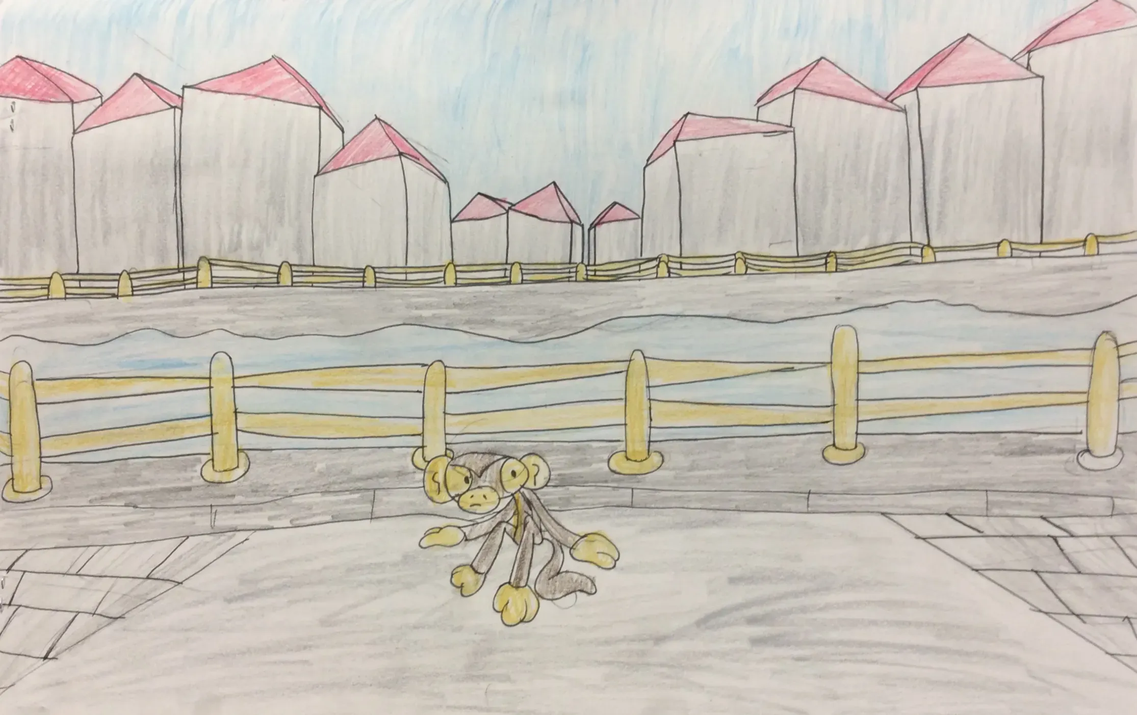 This illustration, created with coloured pencils, depicts a small, monkey-like character with large ears and yellow paws sitting on a grey paved walkway. A yellow wooden fence separates the walkway from a body of water. On the far side of the water, another identical fence lines the front of several tall, grey buildings with red-pointed roofs. The sky above is a pale blue coloured with subtle vertical lines.
