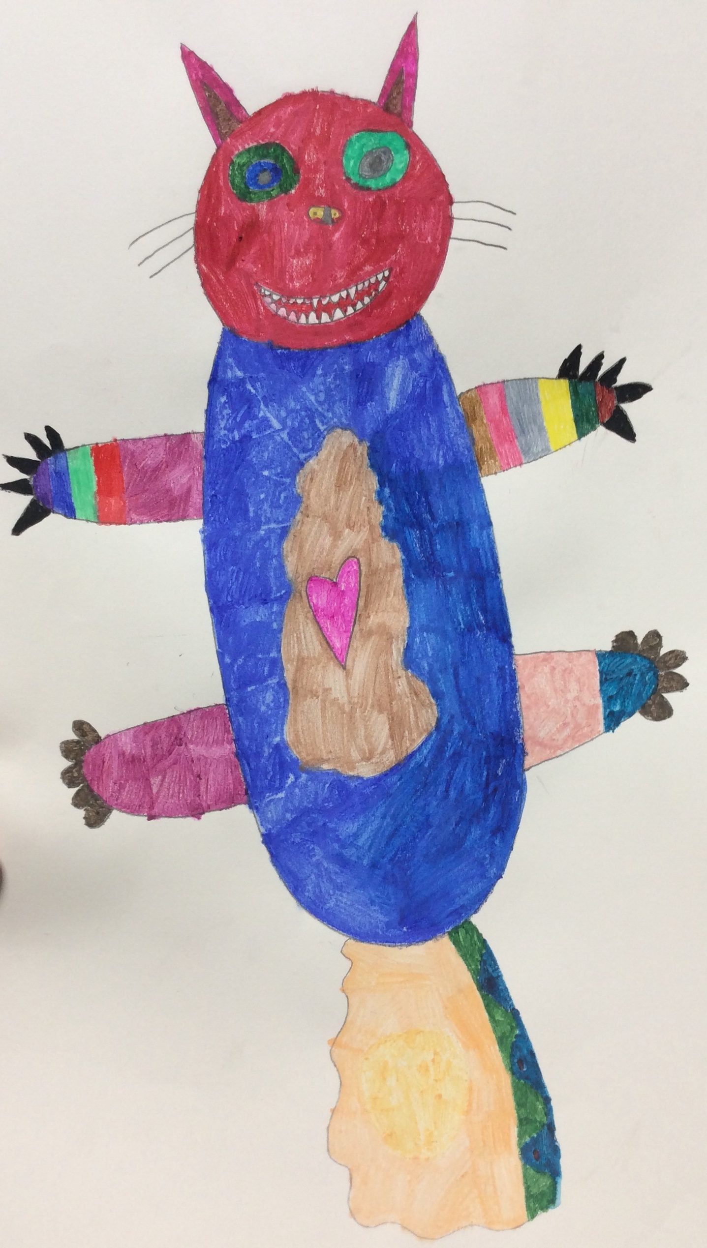 A drawing of a creature with a red cat head and a blue body. The head has green eyes, whiskers, and a big smile with sharp white teeth. In the middle of the blue body is a brown shape with a pink heart. The creature has four arms with colourful stripes and black claws. There is an orange tail at the bottom with a green and blue stripe down the right hand side.